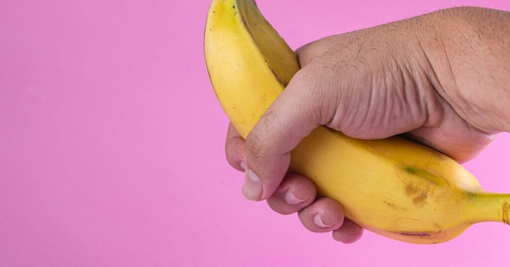 Man holding a banana, illustrating a "dick pic".